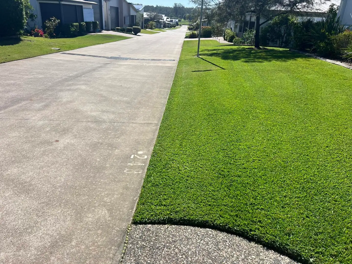Finished lawn edge and driveway presentation at a residential complex